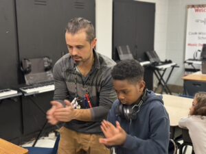 music teacher clapping beats with a student